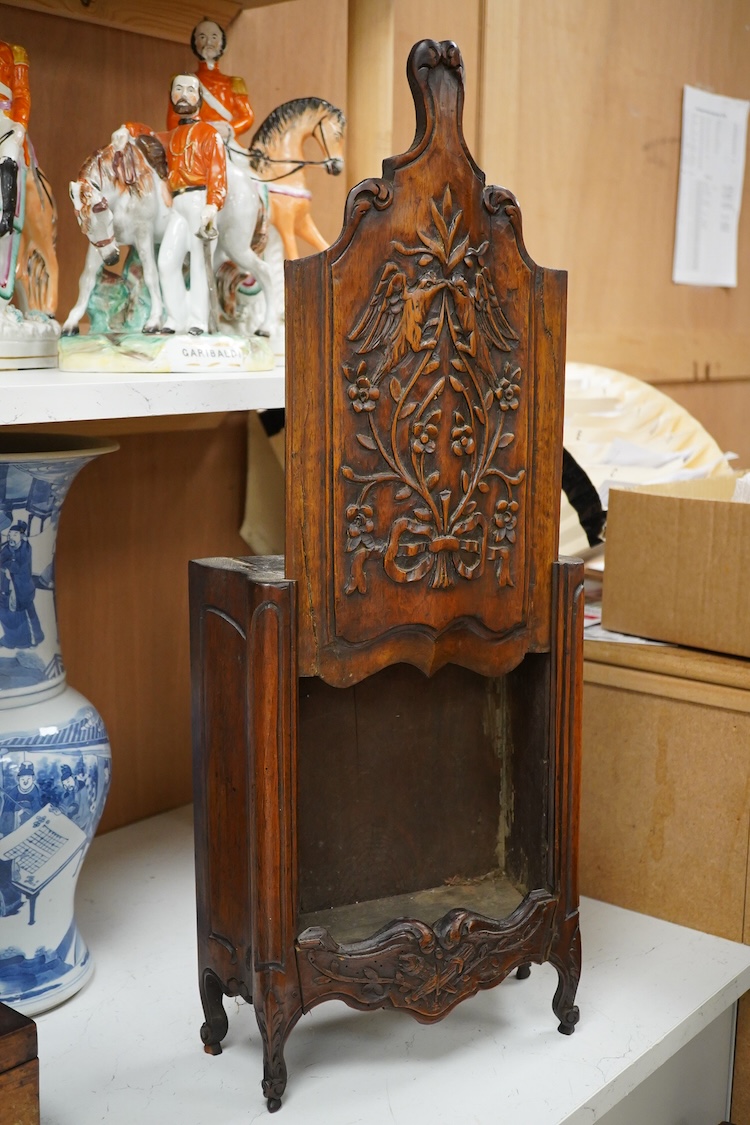 An 18th century French walnut candle box, modelled as a miniature armoire, carved with birds and flowers, 50cm high